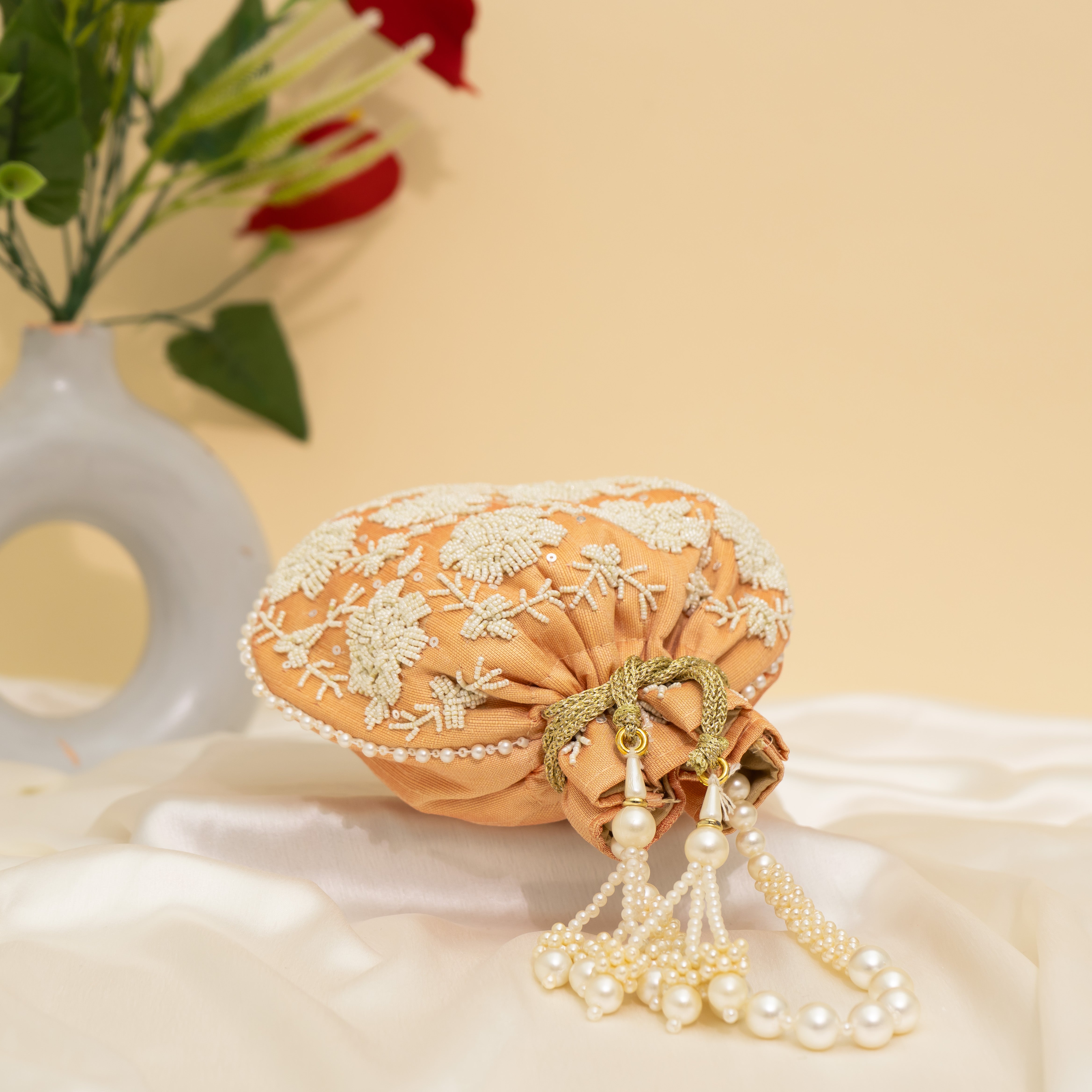 Light Orange Pearl Glow Fantasy Potli